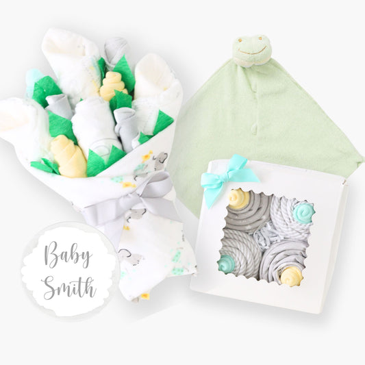 gender neutral newborn baby gift set including layette bouquet, frog lovey, receiving blanket cupcakes, and milestone disc