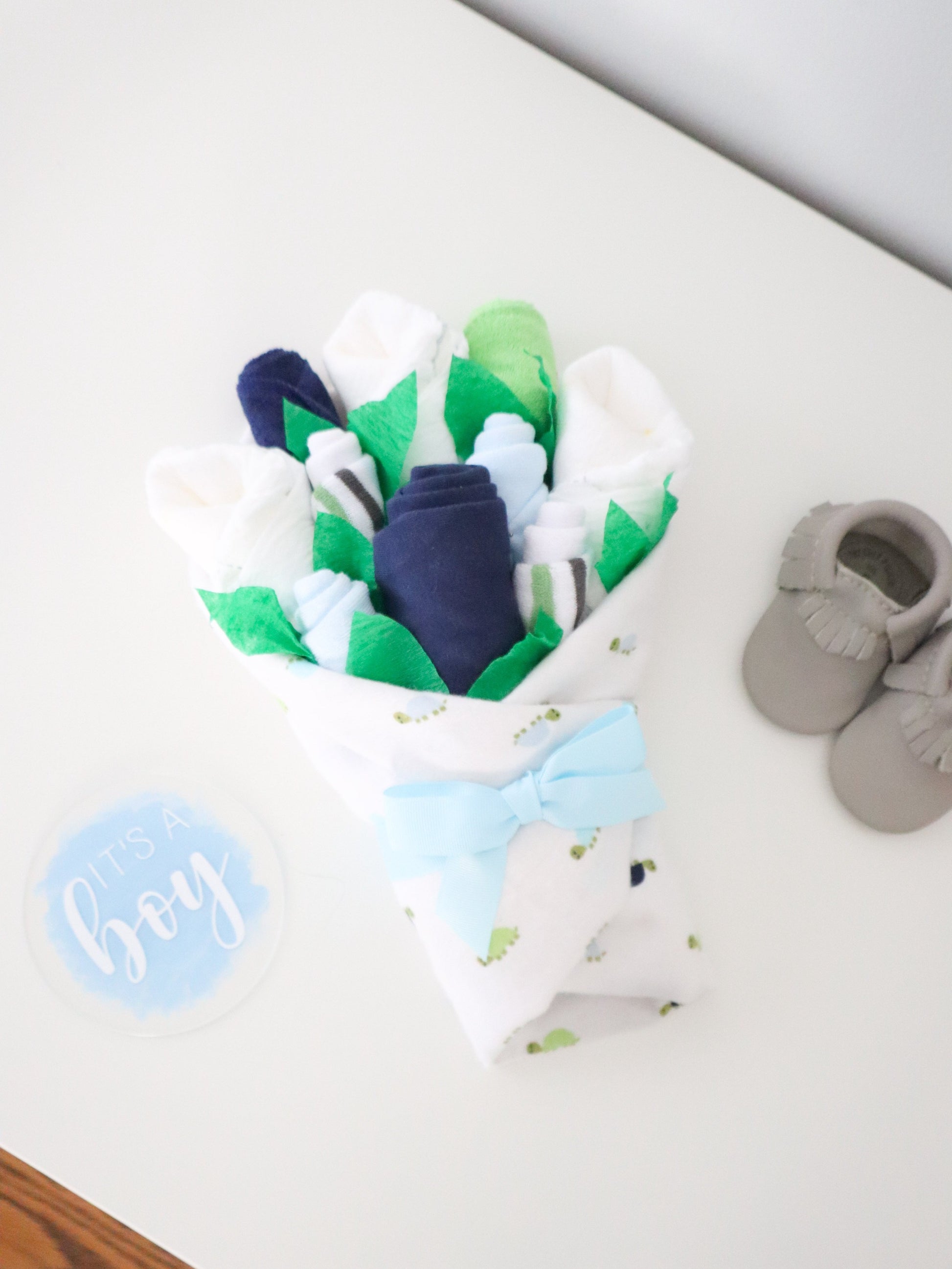 baby boy gift set on dresser with disc and shoes turtles
