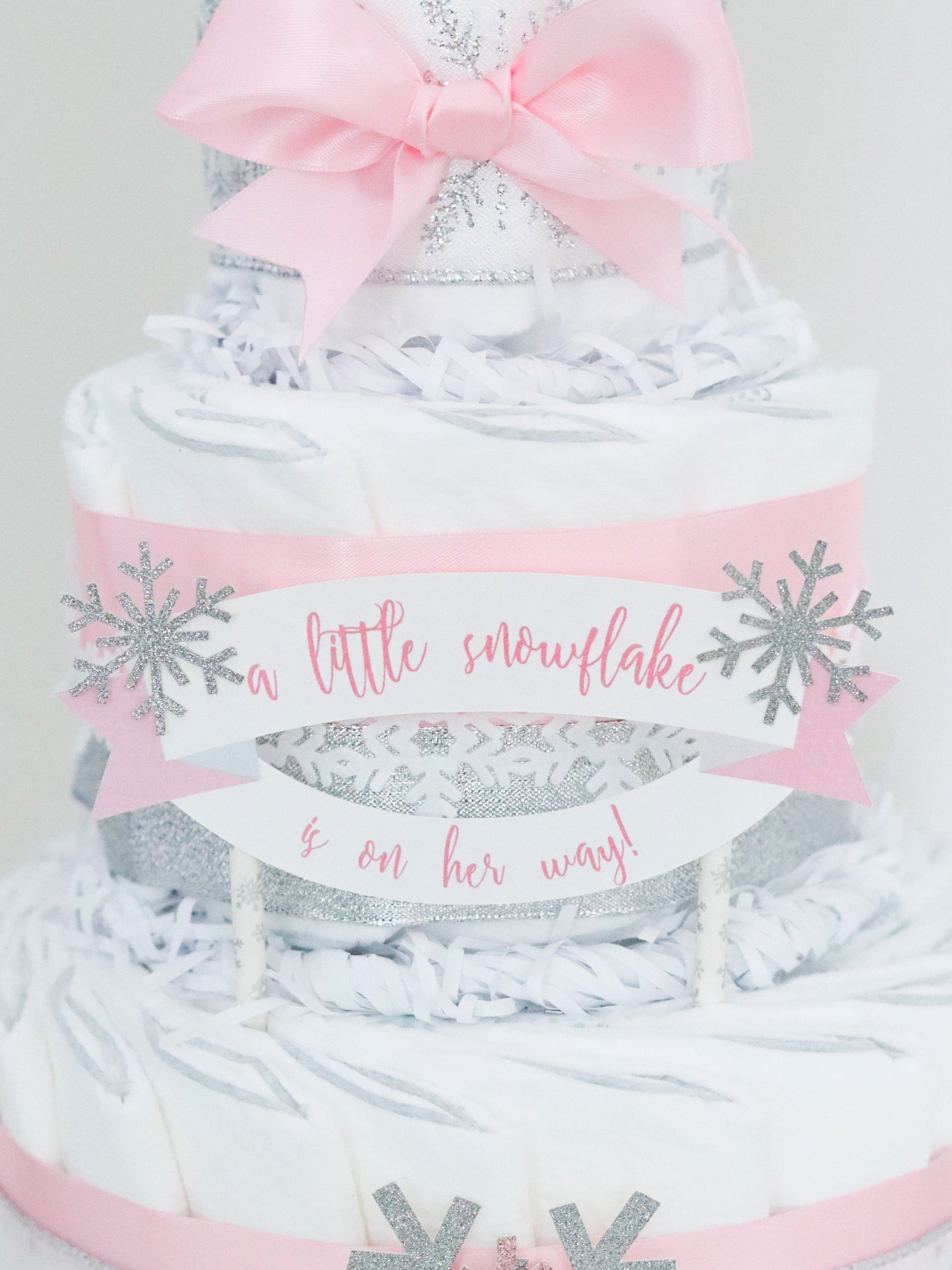 a little snowflake is on her way diaper cake sign