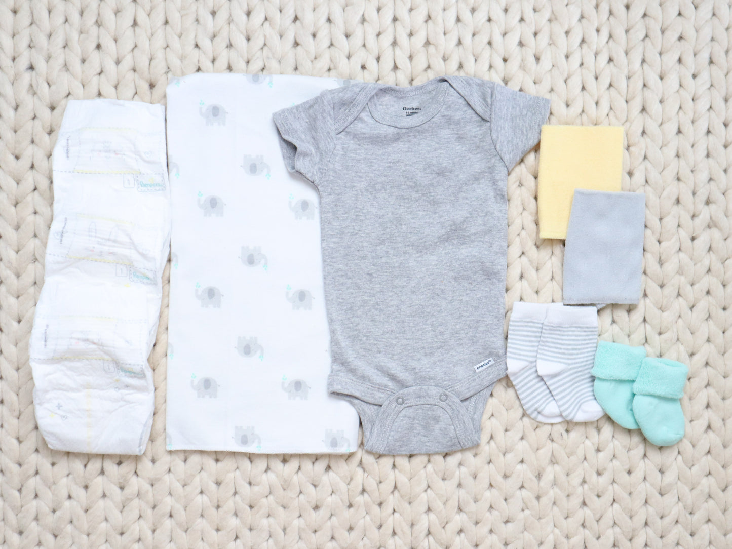 neutral elephant baby gift contents onesie blanket washcloth socks diaper