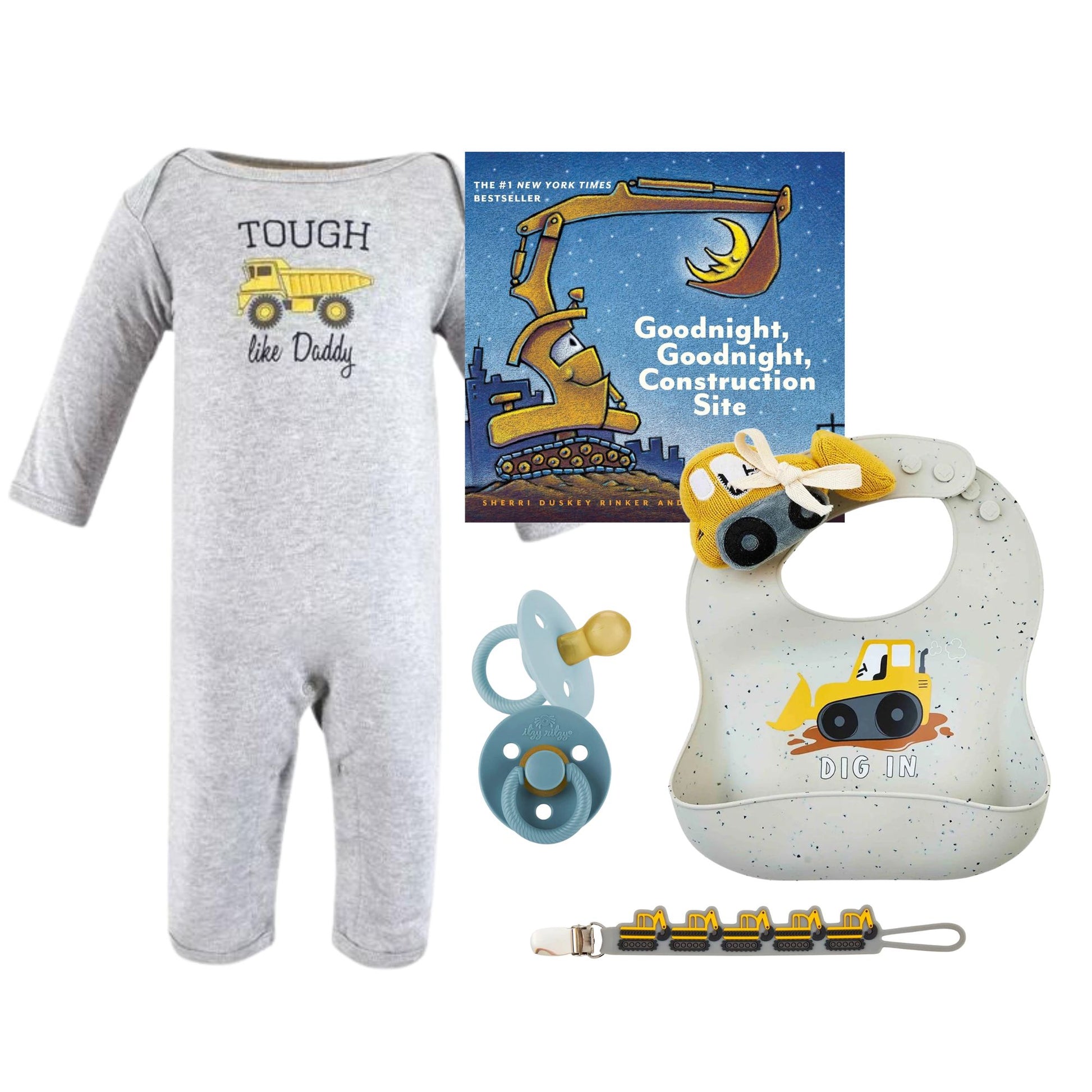 Baby onesie, book, bib, pacifier, and rattle with construction theme on a white background