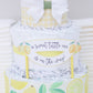 a sweet little one is on the way lemon diaper cake sign
