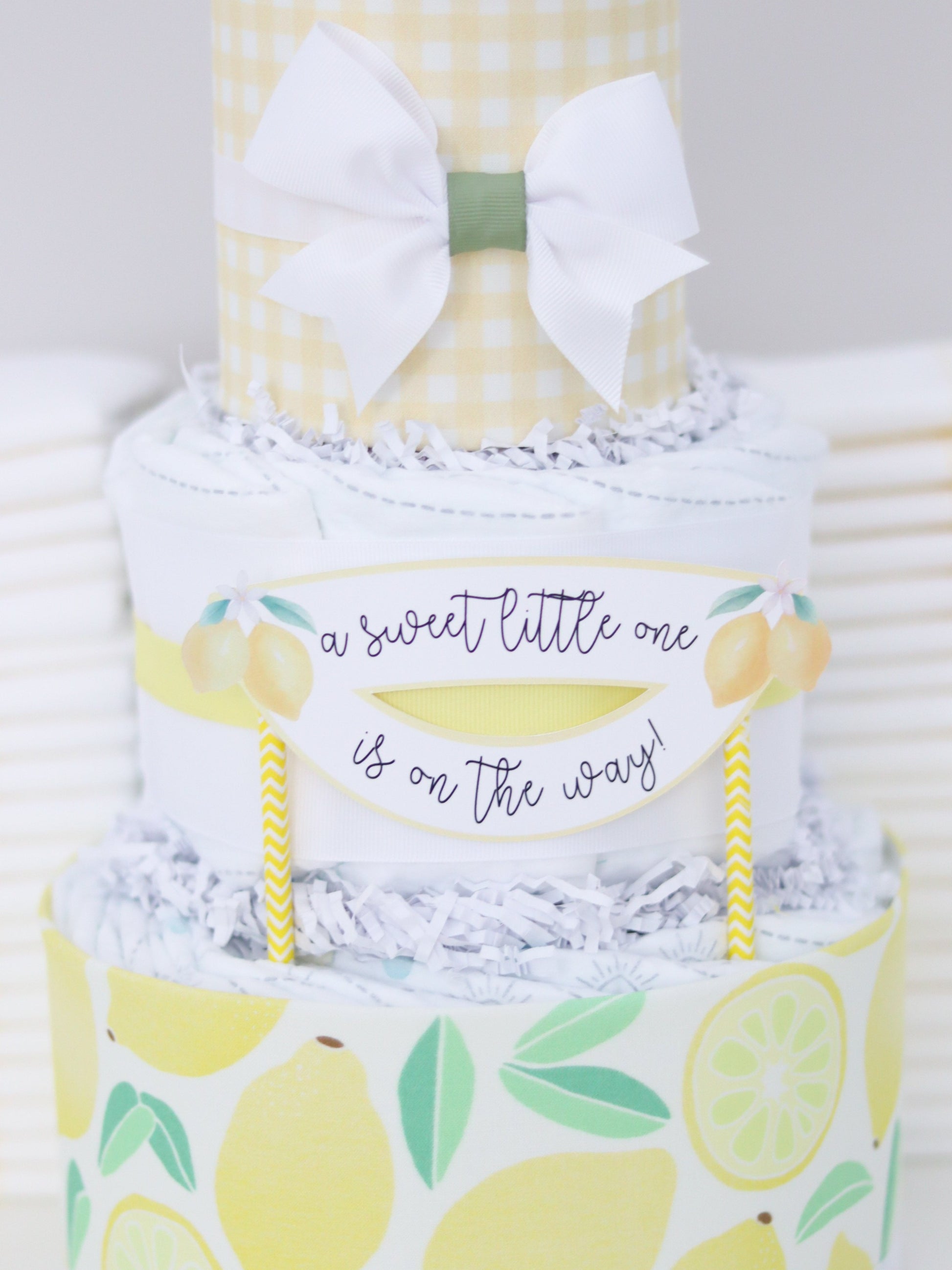 a sweet little one is on the way lemon diaper cake sign