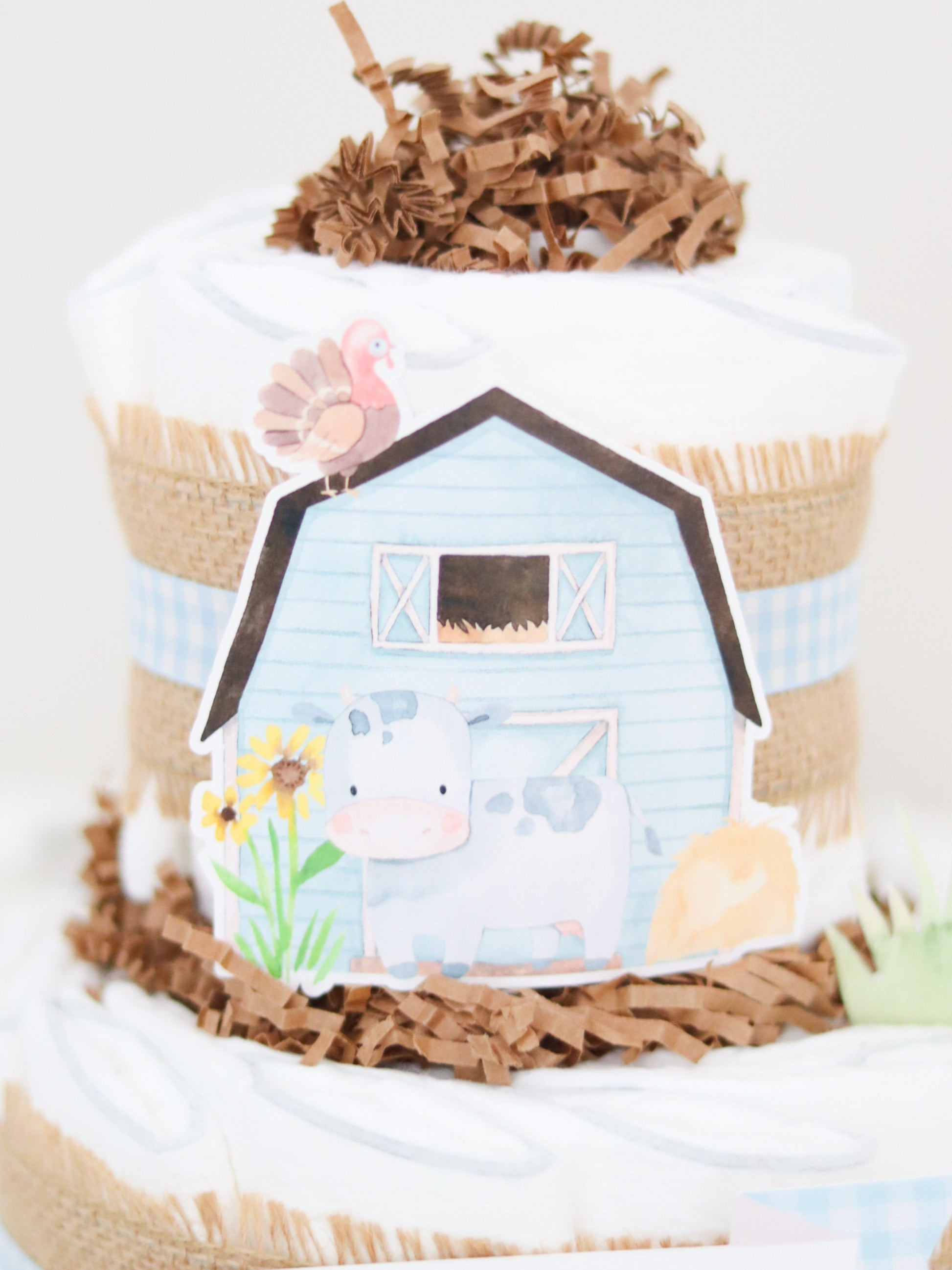 blue barn with cow and sunflowers diaper cake decoration