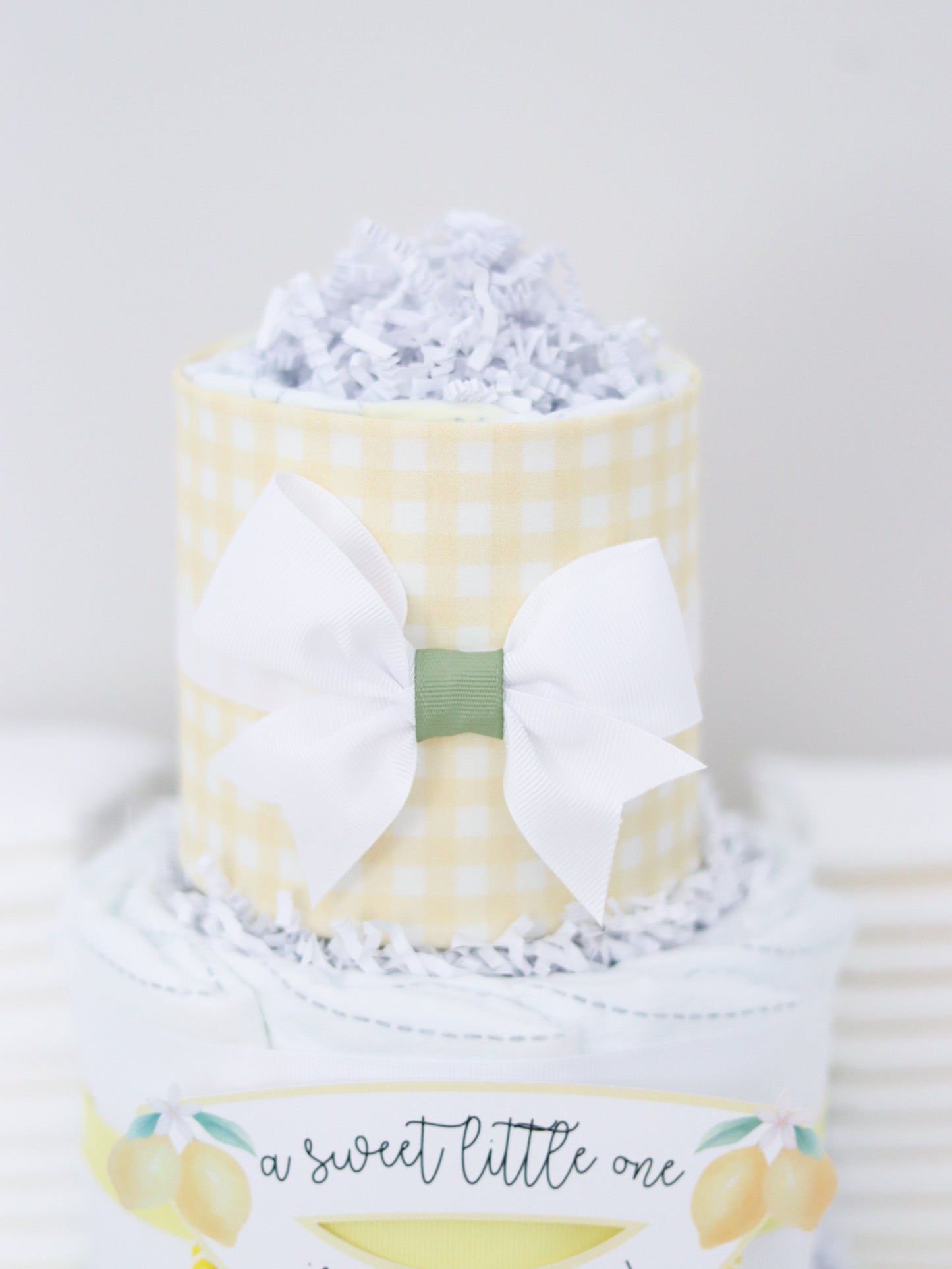 yellow gingham lemon theme diaper cake top with white bow