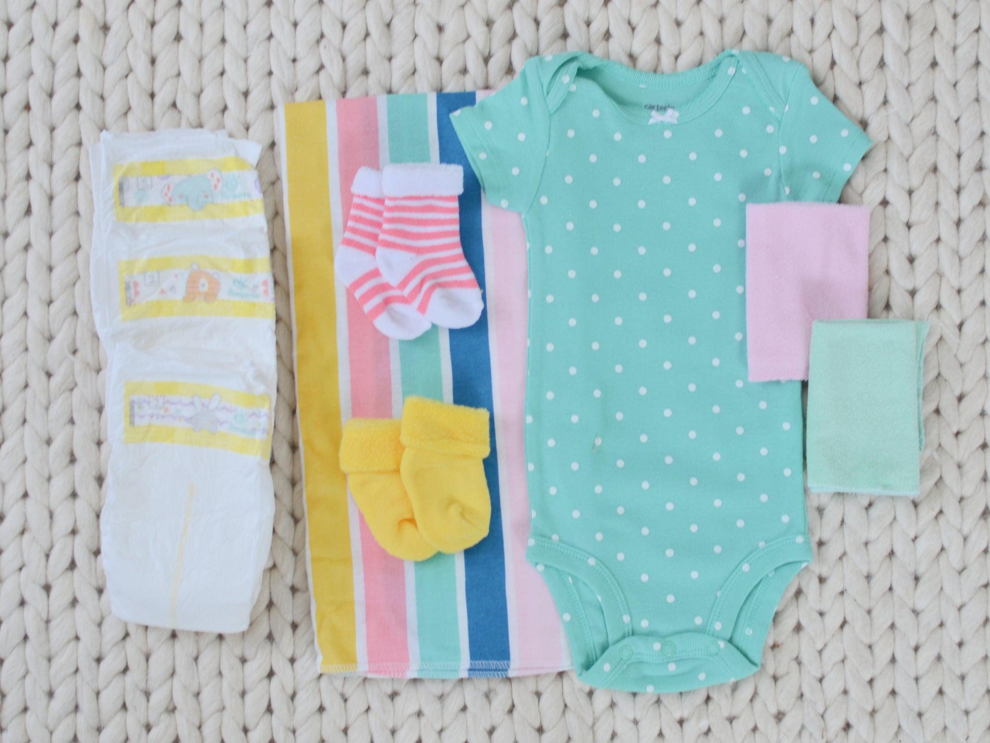baby girl gift set bodysuit washcloths socks receiving blanket and diapers 