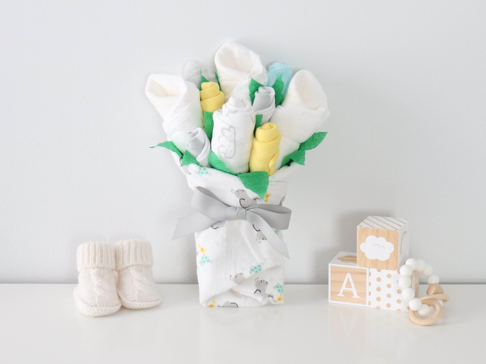 neutral new baby gift clothing flower bouquet